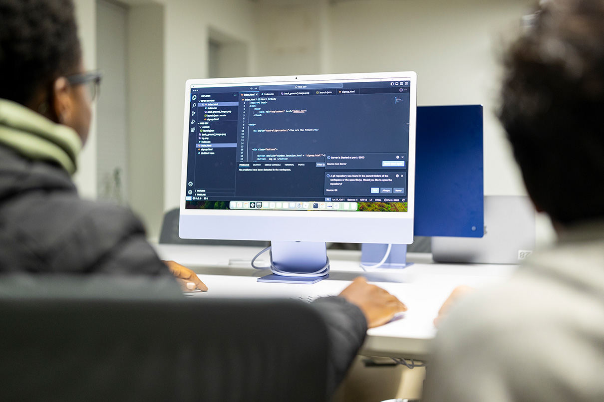 dae student working on computer with code on the screen