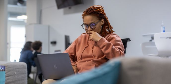 dae student looking focused and working on laptop